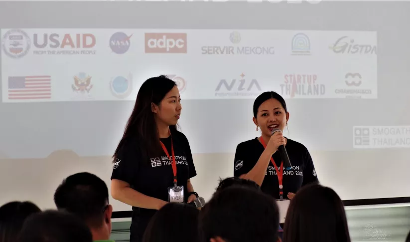 two women speaking at event Thailand