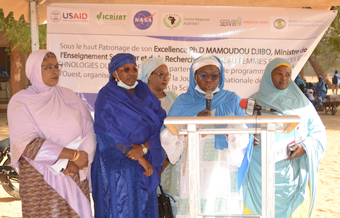 Photo of five women standing at podium, members of the Network of Women in Science and Technology of Niger