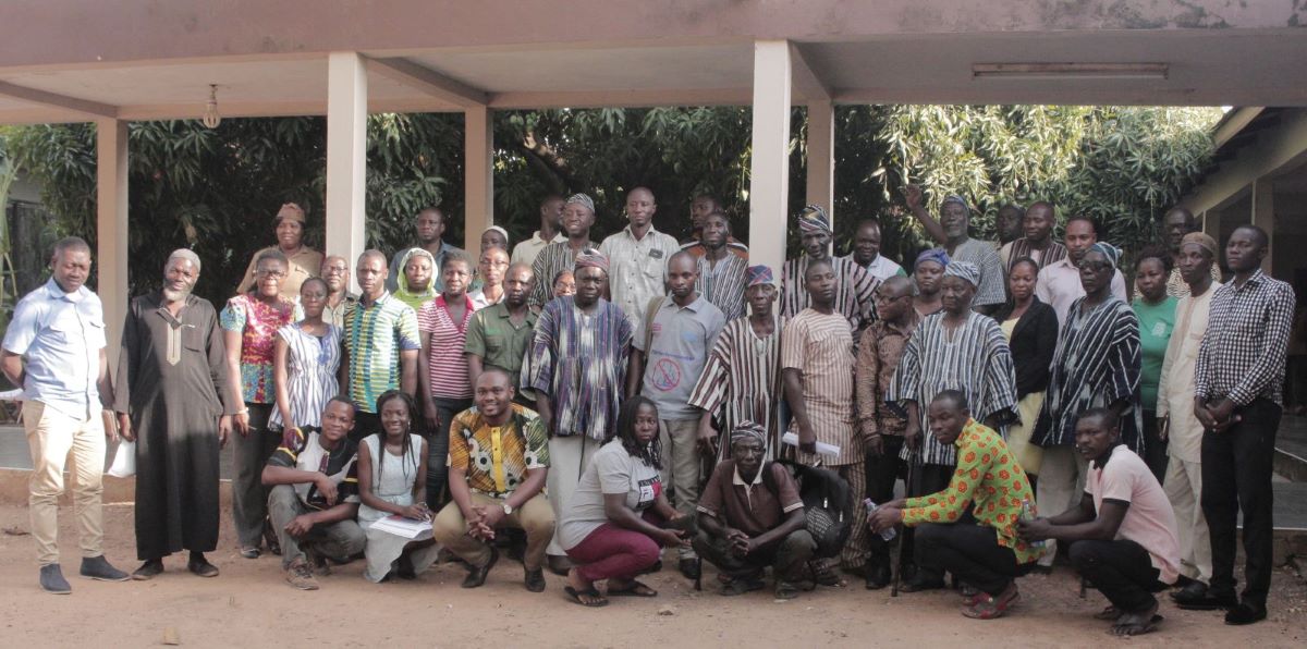 A group photo of people in Ghana outside of a building