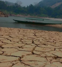 A boat in the water of a dried up river bank