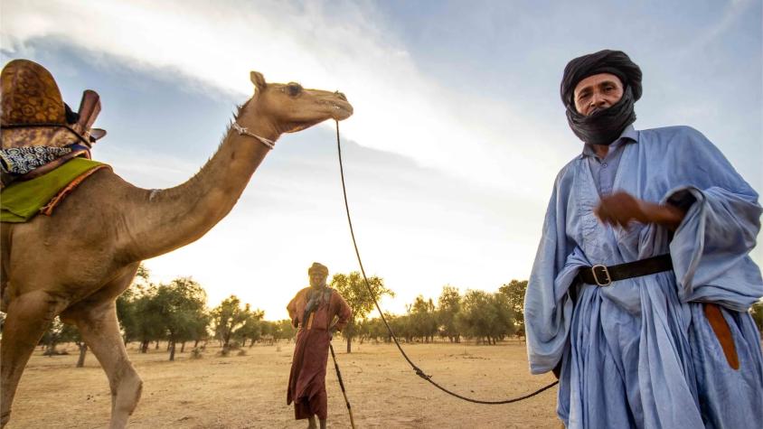 Two nomadic herders and their camel in the arid Ferlo region of Senegal. from the site https://www.raphaelbelminphotography.com/macro-stories/testing-time-for-pastoralists