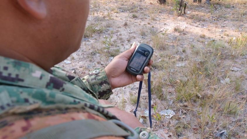 A forest ranger looks at a GPS device in the Prey Lang Forest, Cambodia. Source: https://usaidgreeningpreylang.exposure.co/meet-saminbsp